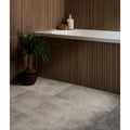 Kinfolk porcelain teak bathroom floor tiles in gray stone effect with subtle texture and natural veining