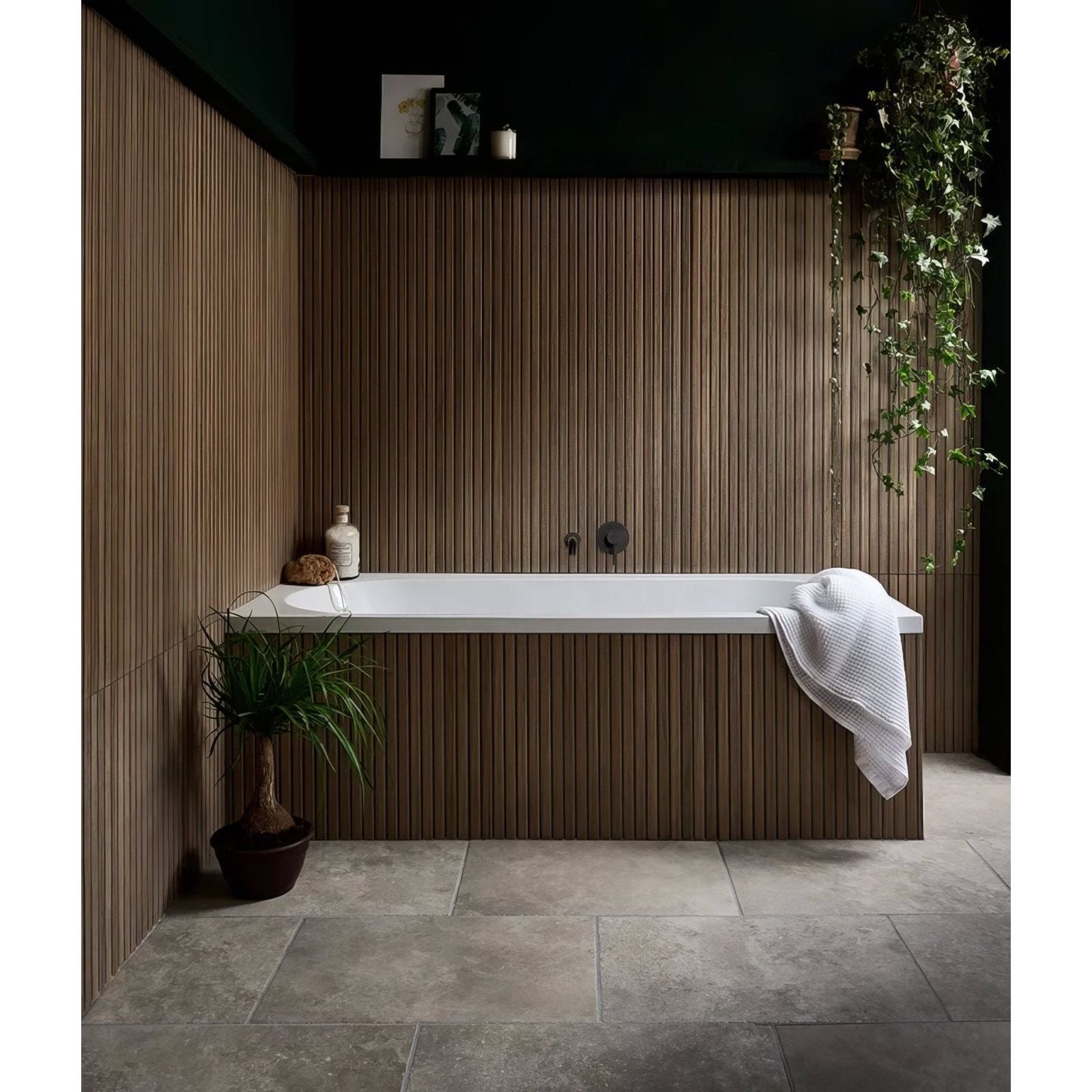 White rectangular bathtub with sleek modern design made of porcelain set against dark wood paneling kinfolk teak