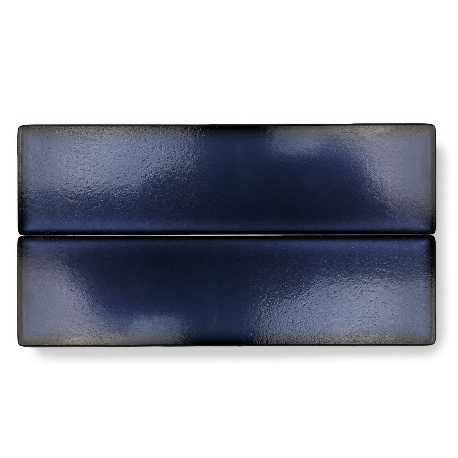 Two rectangular navy blue glossy textured ceramic tiles from kingfisher blue glass wall tile collection