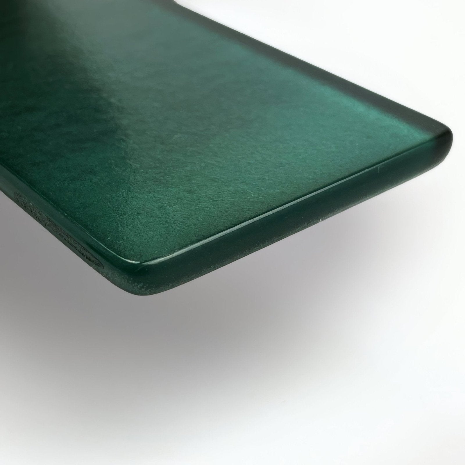 A sleek dark green glass wall tile with a smooth slightly textured surface and rounded edges kingfisher green glass wall tile