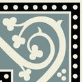 A decorative kitchener corner tile in black on dover white with cream swirling vines and clover motifs on gray background