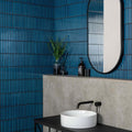 Kitkat Blue Mosaic dark blue ribbed ceramic mosaic with a white vessel sink and black tap