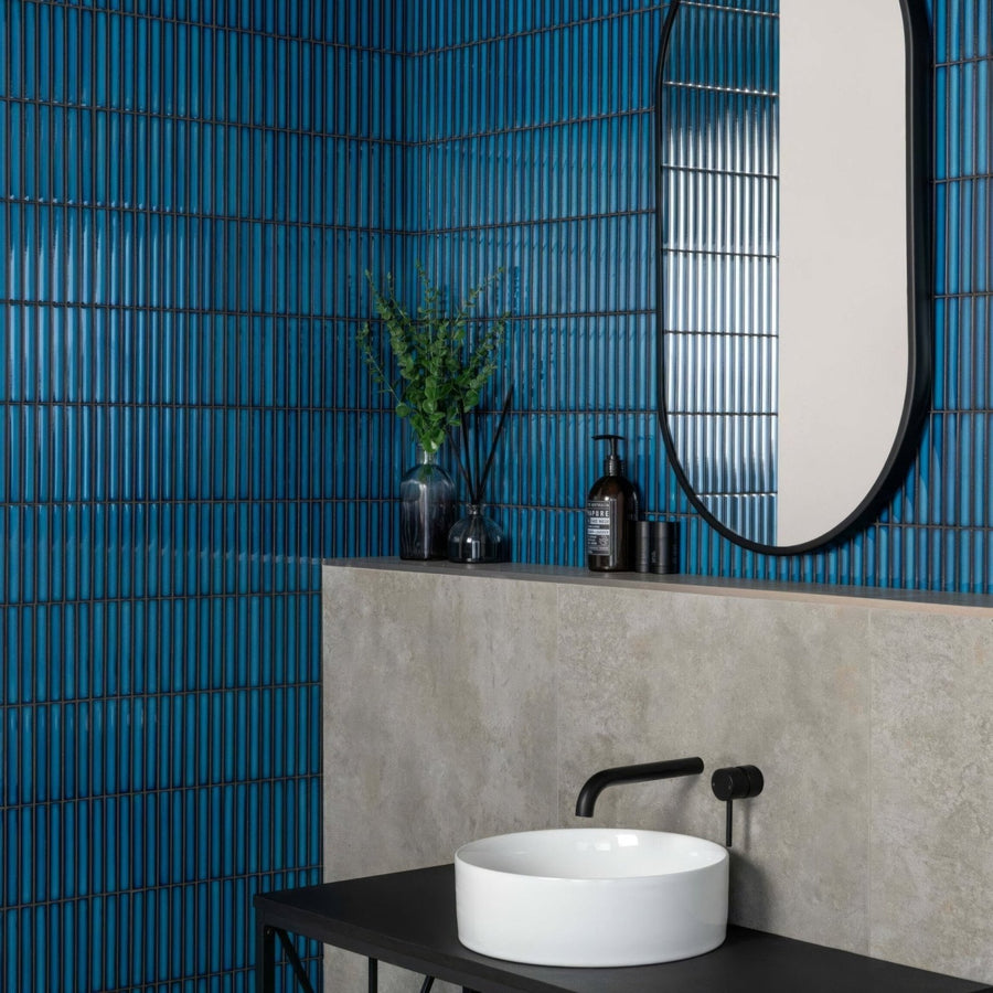Kitkat Blue Mosaic dark blue ribbed ceramic mosaic with a white vessel sink and black tap