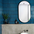 Kitkat Blue Mosaic dark blue ribbed ceramic mosaic with an oval black-framed mirror