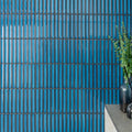 Vibrant blue glossy rectangular ceramic Kitkat blue mosaic tiles arranged in a vertical grid with dark gray grout lines