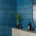 Dark blue ceramic kitkat blue mosaic tile wall with vertical ridged texture and black grout lines