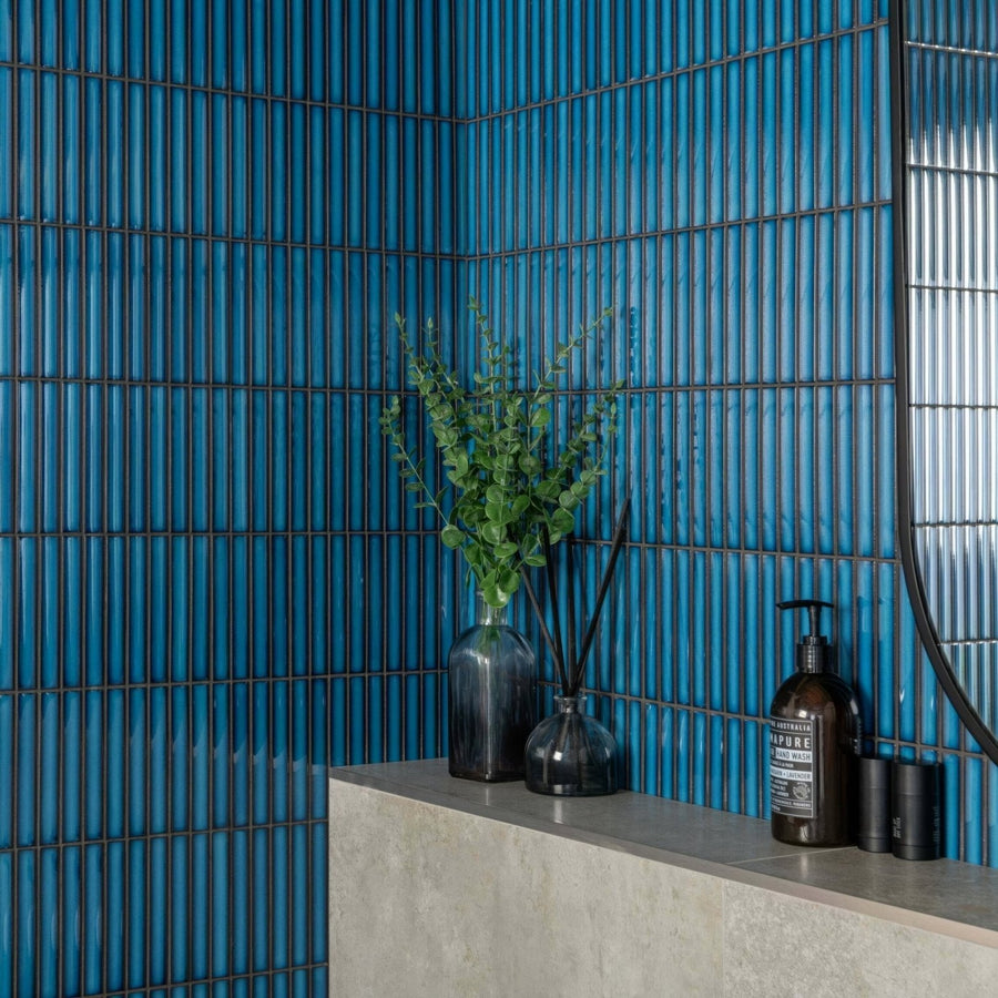 Dark blue ceramic kitkat blue mosaic tile wall with vertical ridged texture and black grout lines