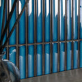 Vibrant blue glossy ceramic kitkat blue mosaic tiles arranged in vertical strips with dark metallic grout