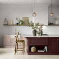 Kitkat White Mosaic white ceramic mosaic countertop on a maroon kitchen island with gold hardware