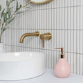 Kitkat White Mosaic white ceramic mosaic with a gold wall-mounted tap