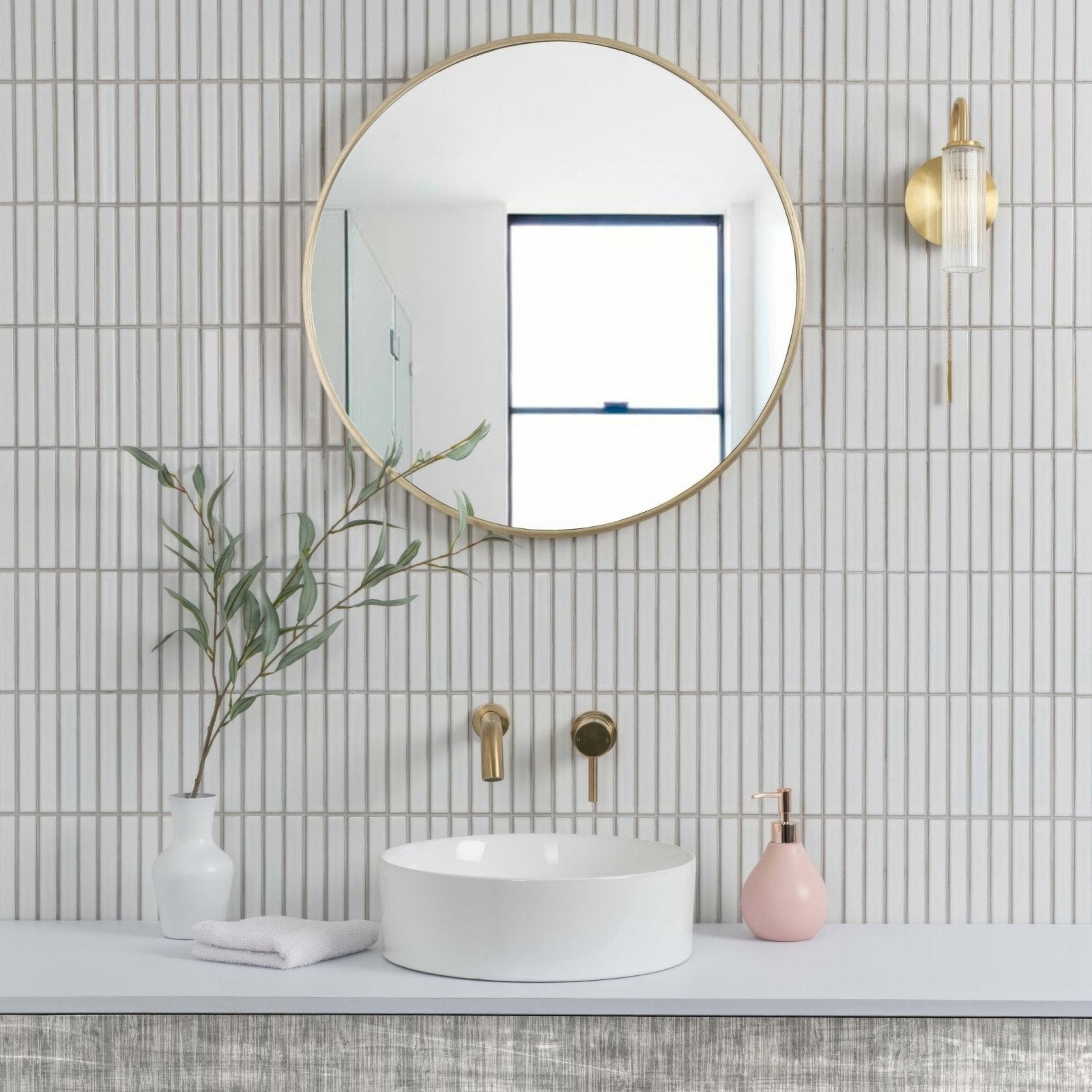 Kitkat White Mosaic white ceramic mosaic with a round gold-framed mirror above a sink