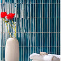 Koeda Sapphire Crackle blue crackle-glaze ceramic mosaic with a white vase of red poppies