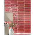Coral-colored glossy rectangular ceramic tiles arranged horizontally featuring crackle texture koeda wild coralito crackle