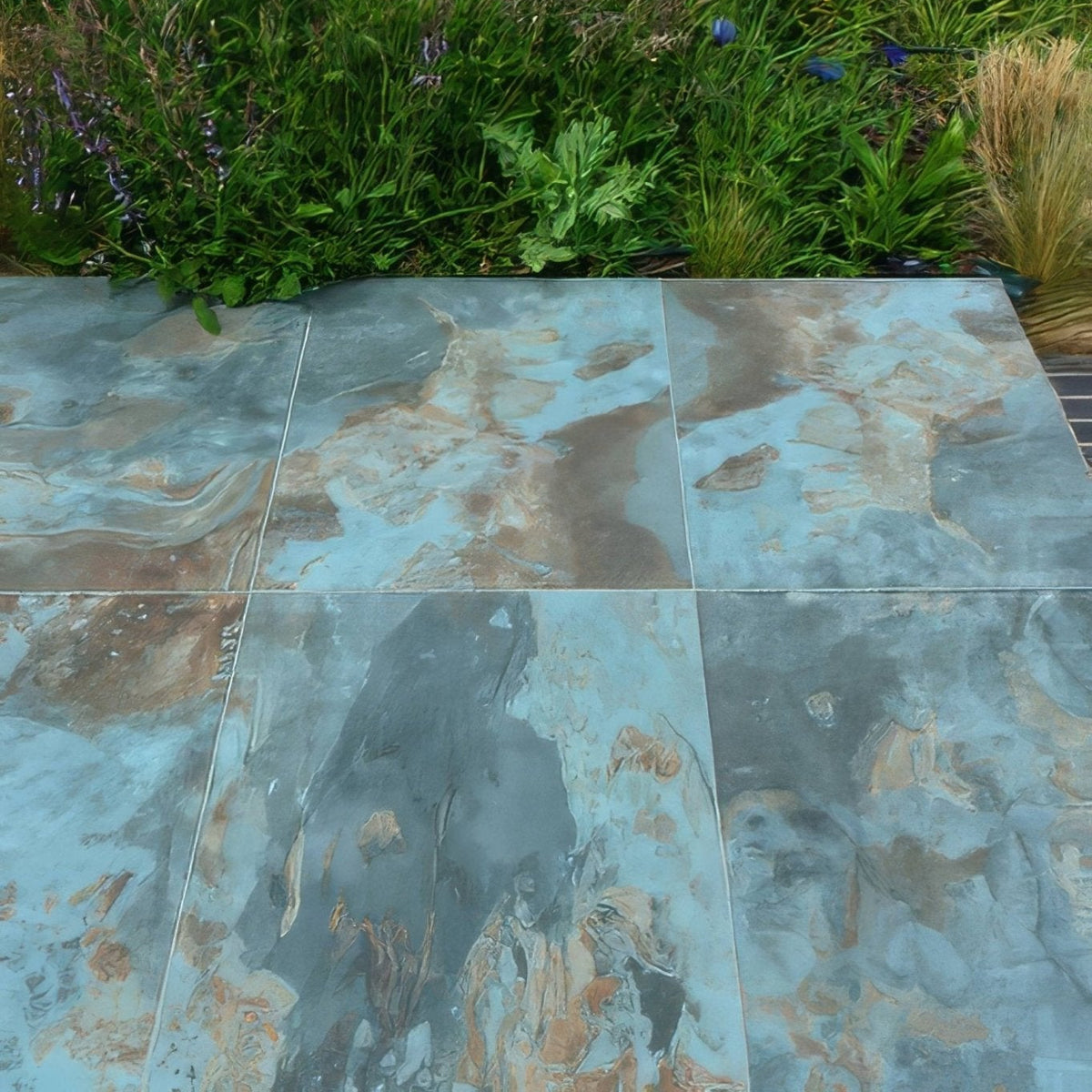 Komodo porcelain paving textured green blue and brown marble-effect patio tiles with natural veined pattern