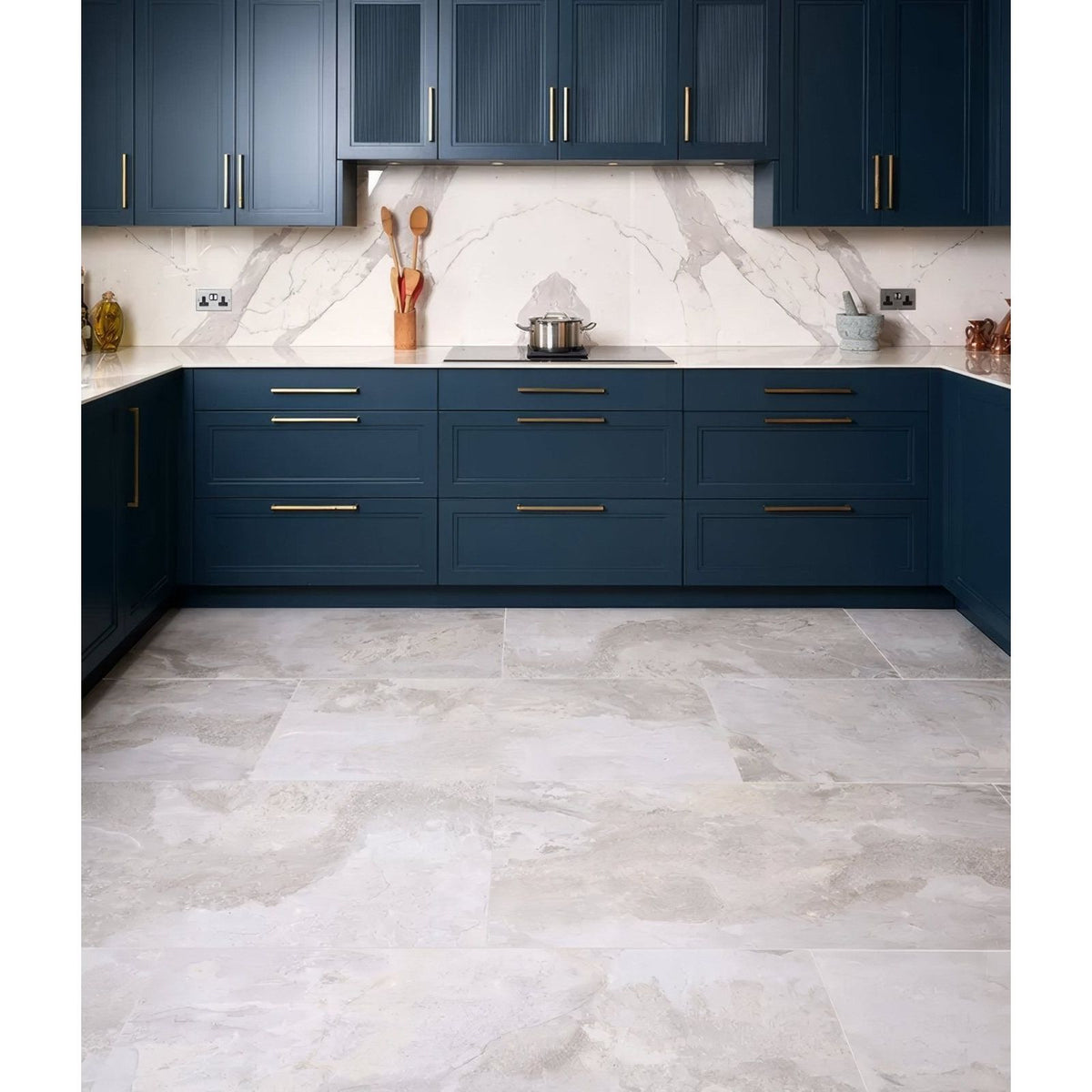 Komodo Porcelain White white marble-effect tiles as a countertop with deep blue cabinetry