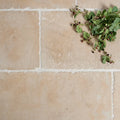 Beige lacock limestone heritage finish stone tiles with subtle natural veining and white grout lines