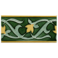 Green ceramic lafleur border tile with raised light green and gold leafy vine patterns and thin gold trim on victorian green
