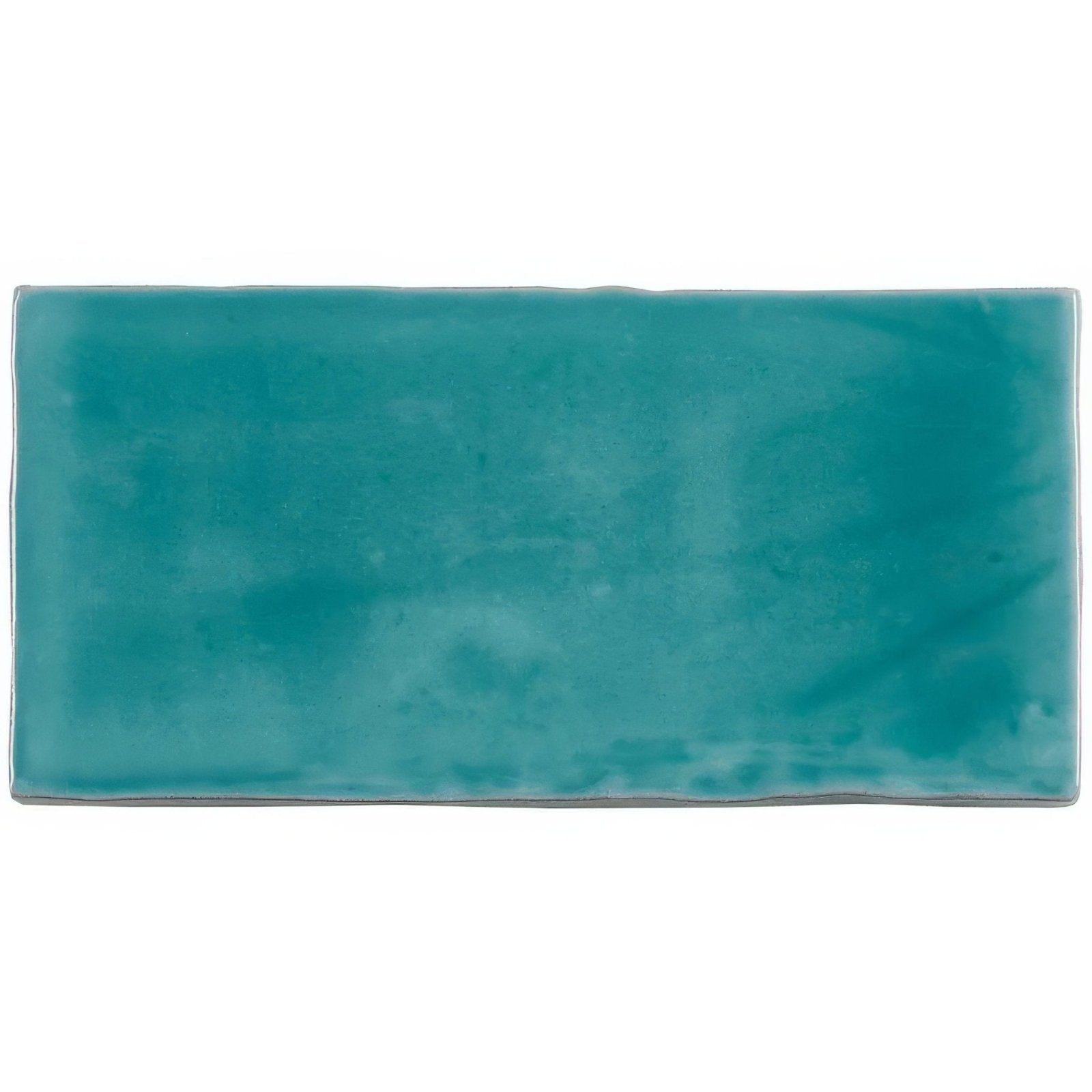 A rectangular teal ceramic lagoon half tile wall tile with a matte slightly textured finish