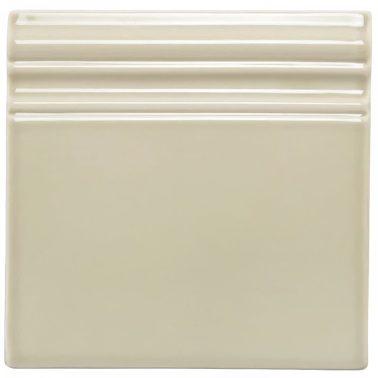 Cream-colored square ceramic lavenham artisan skirting tile with three horizontal ridges along the top edge