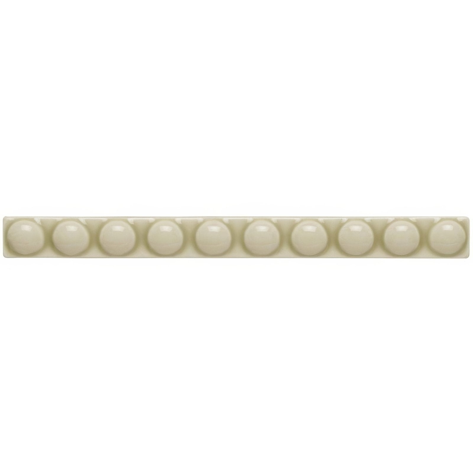 Cream-colored ceramic tile lavenham empire with a row of evenly spaced glossy spherical beads embedded along its length