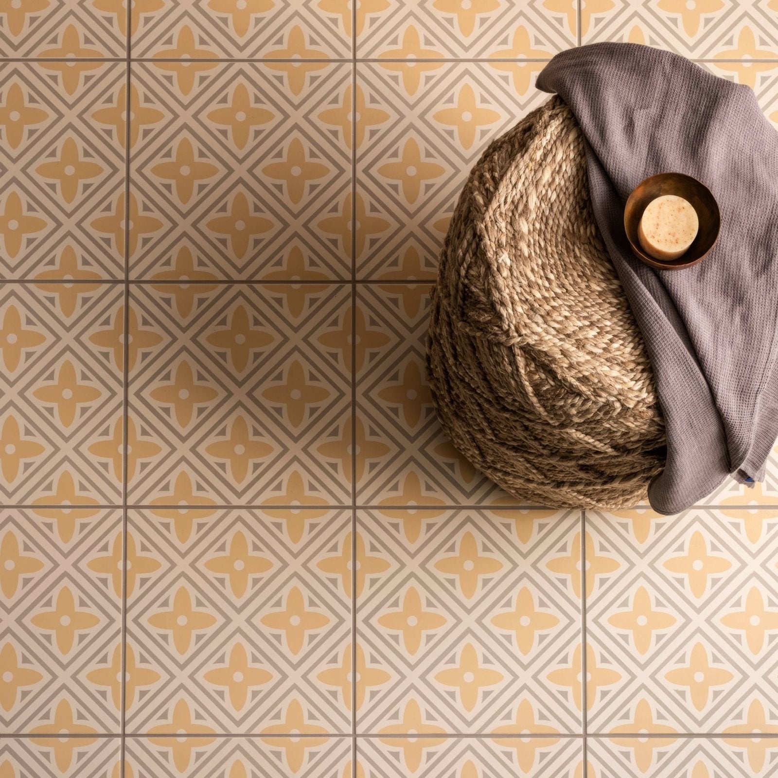 A textured beige and gray geometric patterned tile floor in leigh yellow on chalk finish