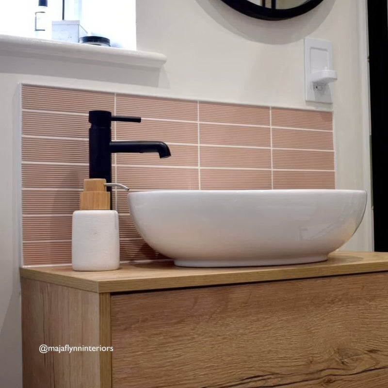 White ceramic vessel sink levante ridge clay with sleek black faucet on light wood vanity for modern bathrooms