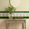 Clear ribbed glass vase holding greenery displayed on liberty tube-lined single tile in county white color