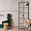 Lin porcelain 59.2 x 59.2cm green freestanding bathtub with white rim and pink towel draped over the side