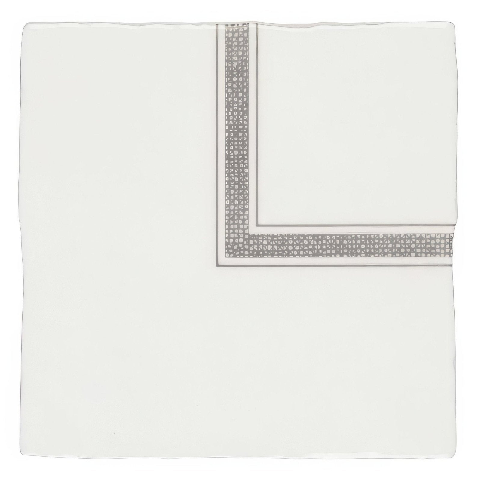 A crisp white silk pocket square with a silver geometric pattern on folded edges from linen corner grey on cotton