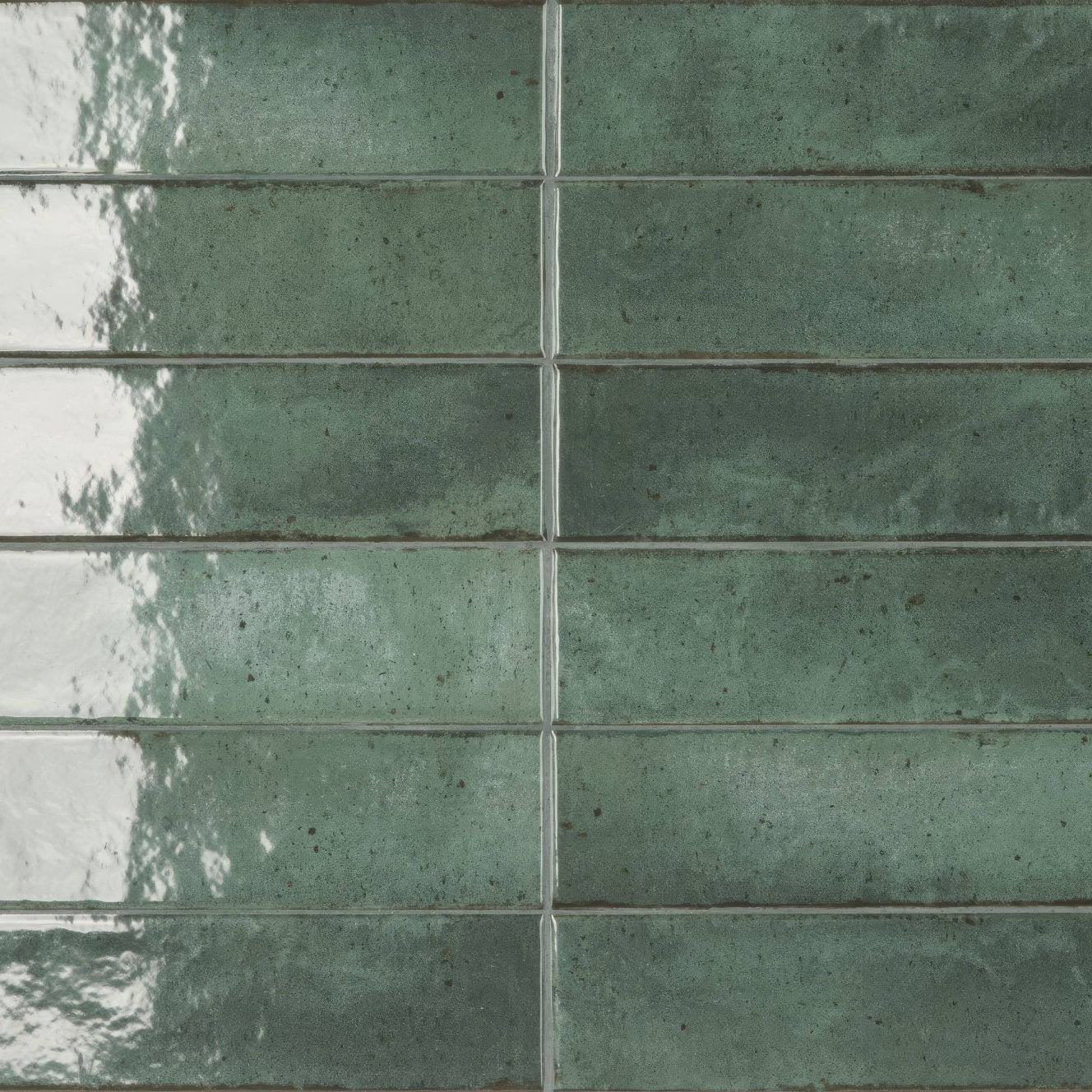 Green ceramic subway tiles with a speckled glossy finish in Lisbon green jade shine color