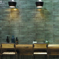 Green rectangular ceramic tiles with a matte textured finish forming a wall in Lisbon green jade shine design