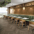 Green upholstered booth seating with wooden frame and matching shelves in Lisbon terracotta shine design