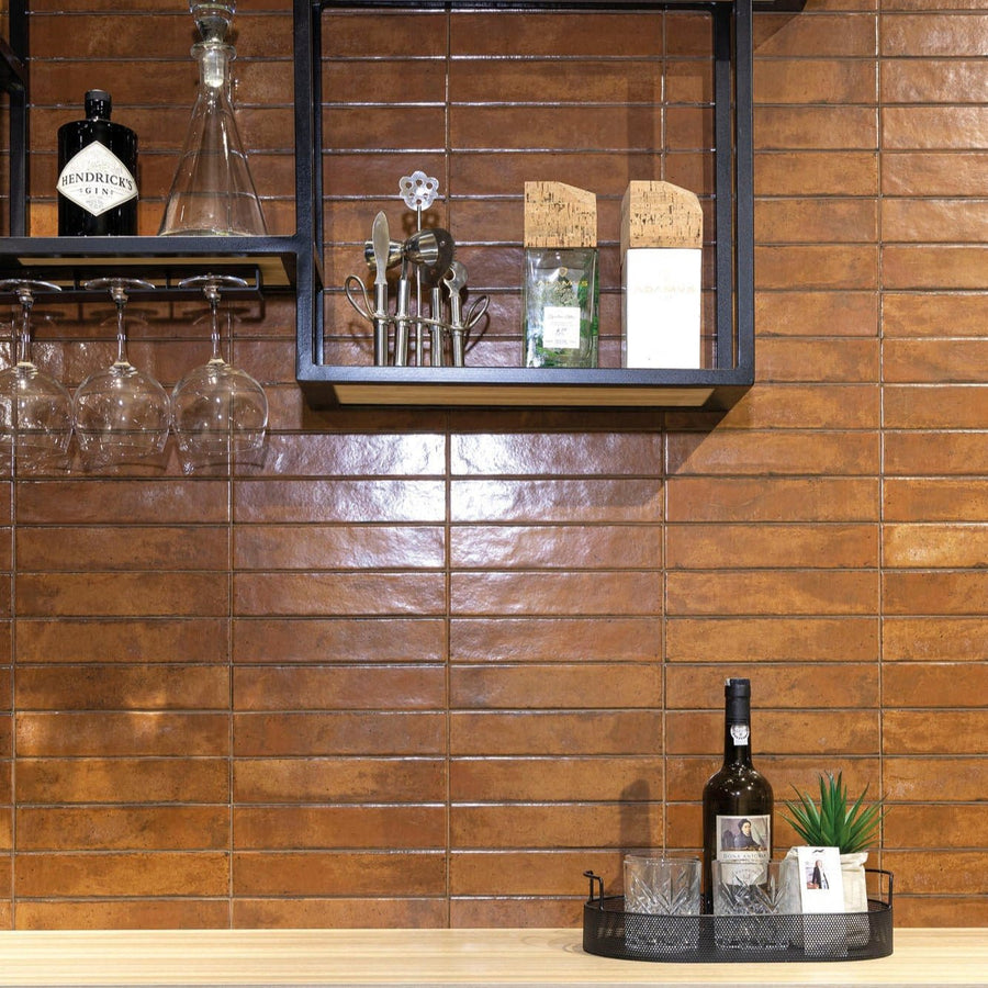 Copper-toned rectangular glossy wall tiles arranged horizontally from the lisbon terracotta shine collection