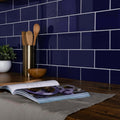 Deep blue glossy ceramic subway tiles with white grout form a sleek modern kitchen backsplash liso azul gloss 100x200