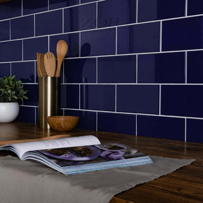 Deep blue glossy ceramic subway tiles with white grout form a sleek modern kitchen backsplash liso azul gloss 100x200