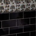 Liso Black Gloss 100x200 black glossy subway tiles with decorative tropical bird and foliage border on muted blue background