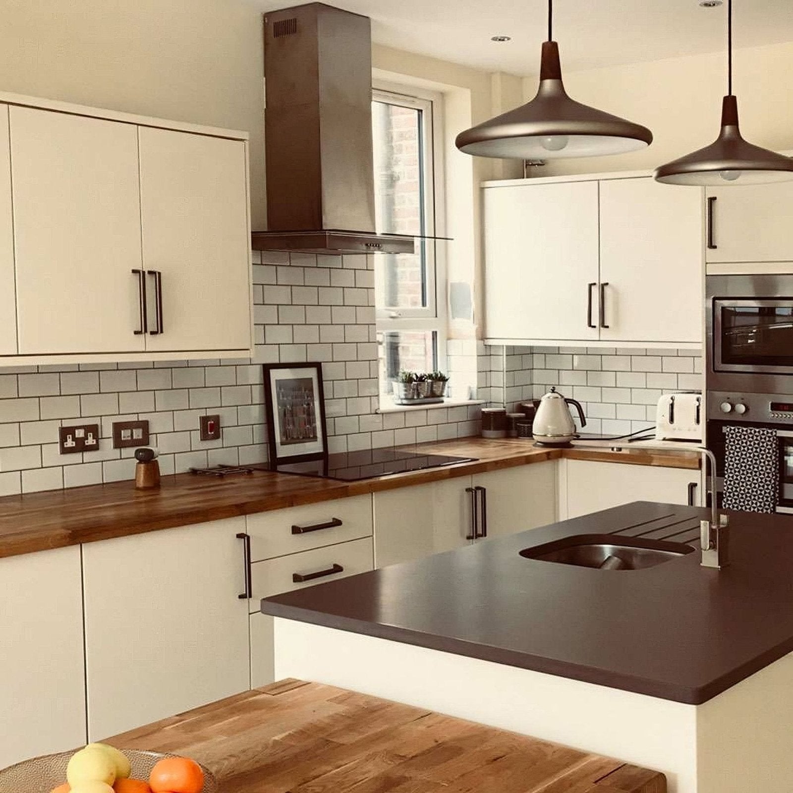 Modern kitchen featuring liso white gloss 100x200 white cabinets with dark wood countertops and stainless steel range hood