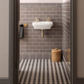 White ceramic wall-mounted london stone albert moulding sink with gold-toned faucets and plumbing