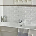 White subway tile backsplash with subtle raised texture and uniform rectangular pattern from london stone albert moulding