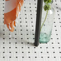 Long Island Marble Wicker Mosaic woven marble mosaic with a clear glass bottle holding a green rose