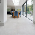Modern blue velvet dining chairs with slender gold legs paired with louvre porcelain blanc 80 x 80cm table