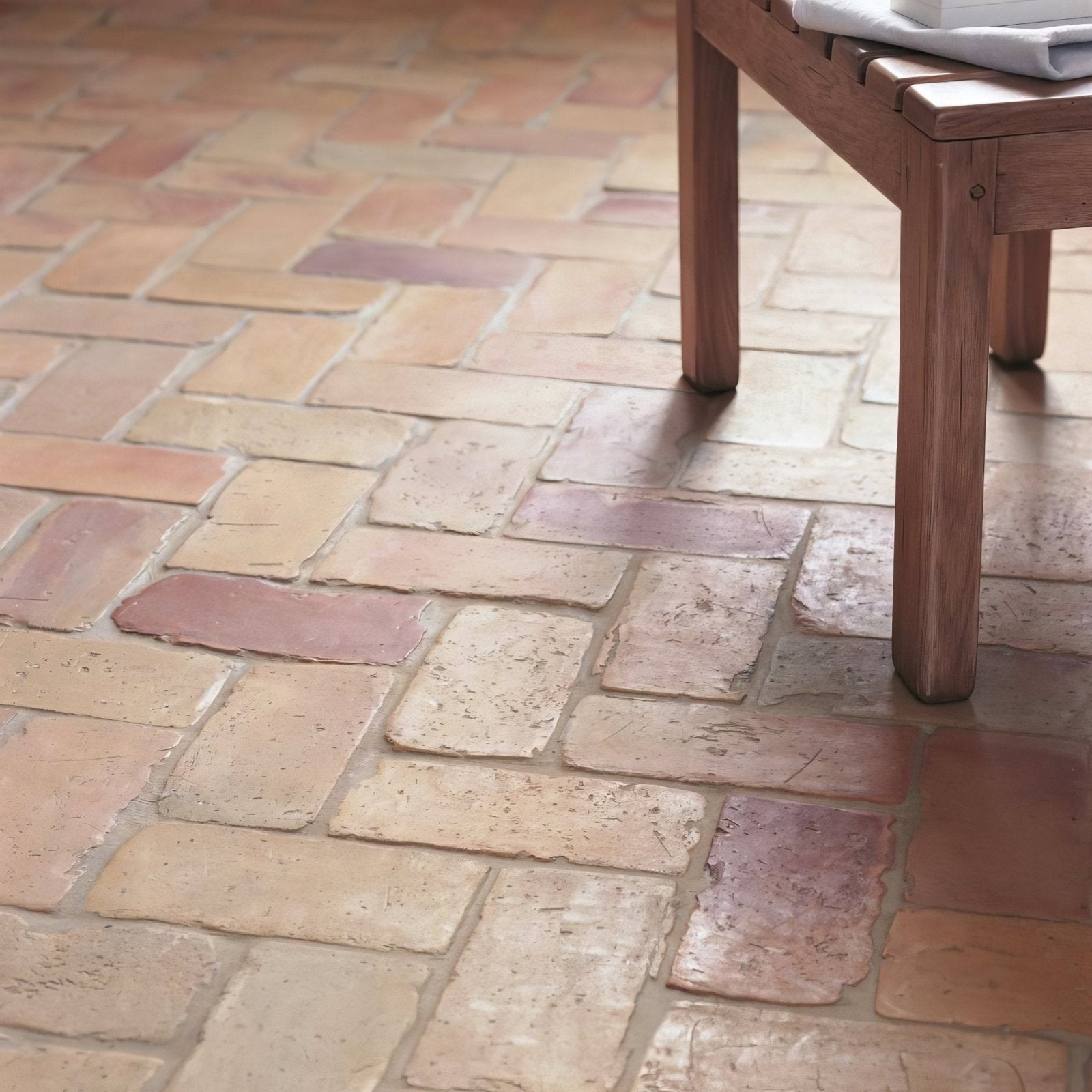 Lubelska brick terracotta rustic terracotta-colored rectangular floor tiles arranged in a herringbone pattern