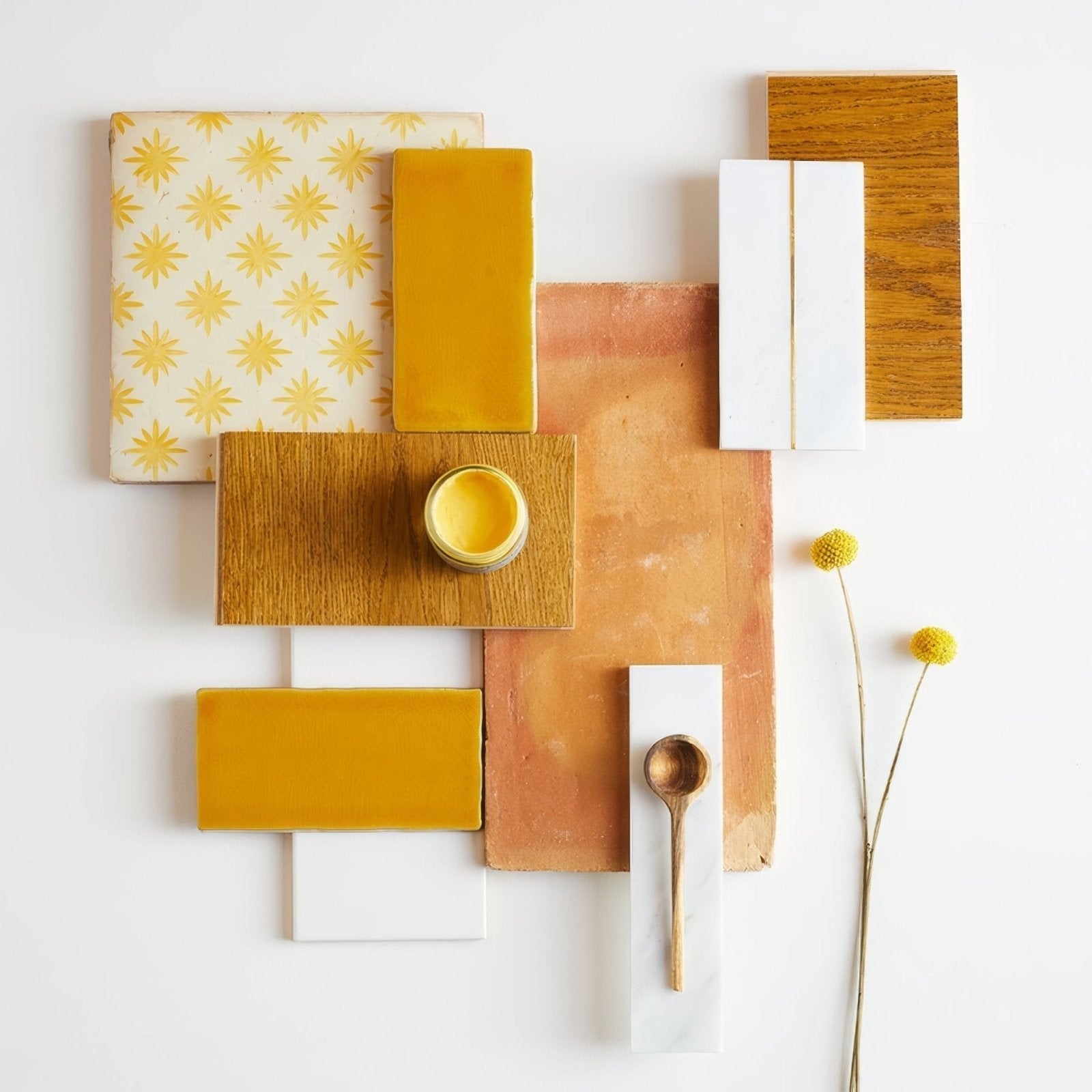 A small round yellow ceramic jar with a glossy finish on a wooden tile from lubelska brick terracotta collection