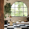 Lucca Statuario Venato white marble-effect tiles with an arched black-framed window