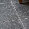 Ludlow porcelain charcoal dark gray stone tiles with subtle white veining and textured surfaces separated by thin grout lines