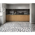 Black and white mosaic tile floor with irregular geometric patterns from luminous lume black collection