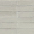 Light gray rectangular ceramic tiles arranged in a neat grid pattern from luminous lume classic white collection