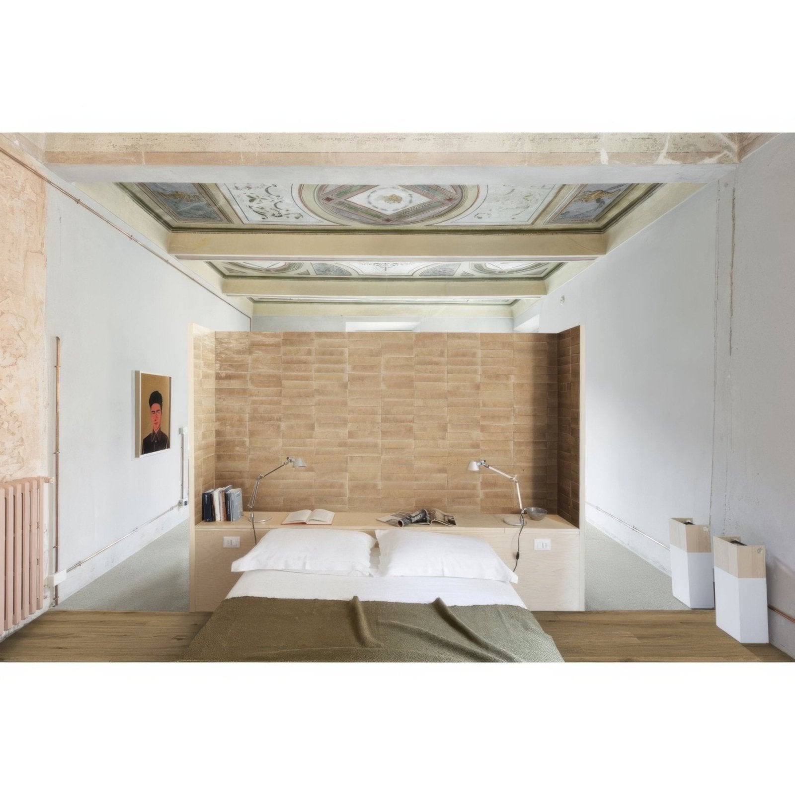 A minimalist bed with a wooden headboard and olive green bedding in a room featuring luminous lume pesca-rosa pink gloss tiles