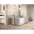 Lyon 1836 Vison Matt beige marble-effect tiles with a freestanding bathtub and chrome tap