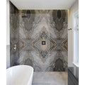 The Magnifique porcelain nero bookmatched shower wall features a striking symmetrical marble pattern with gray and beige veins